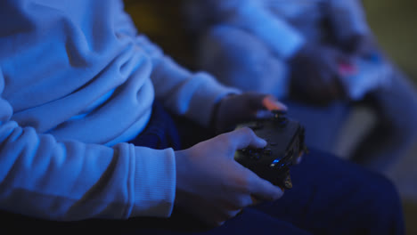 Close-Up-Of-Two-Young-Boys-At-Home-Playing-With-Computer-Games-Console-On-TV-Holding-Controllers-Late-At-Night-9